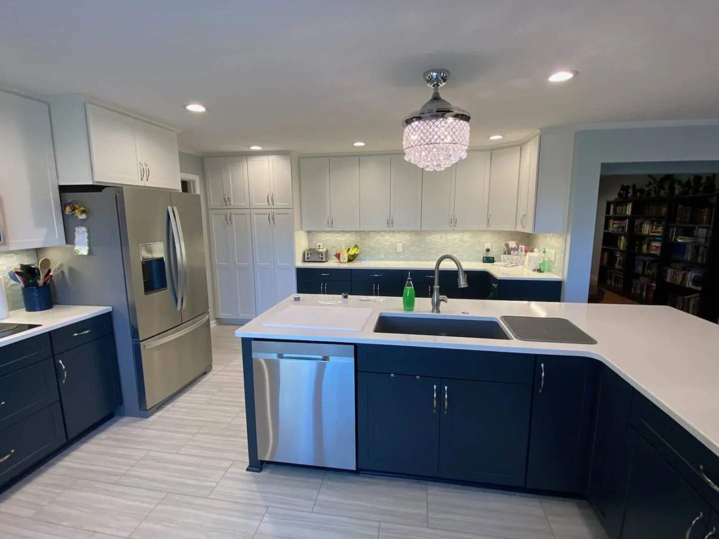 Navy and white factory cabinet kitchen with quartz island